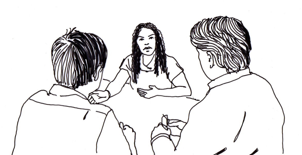 3 people talking at a table